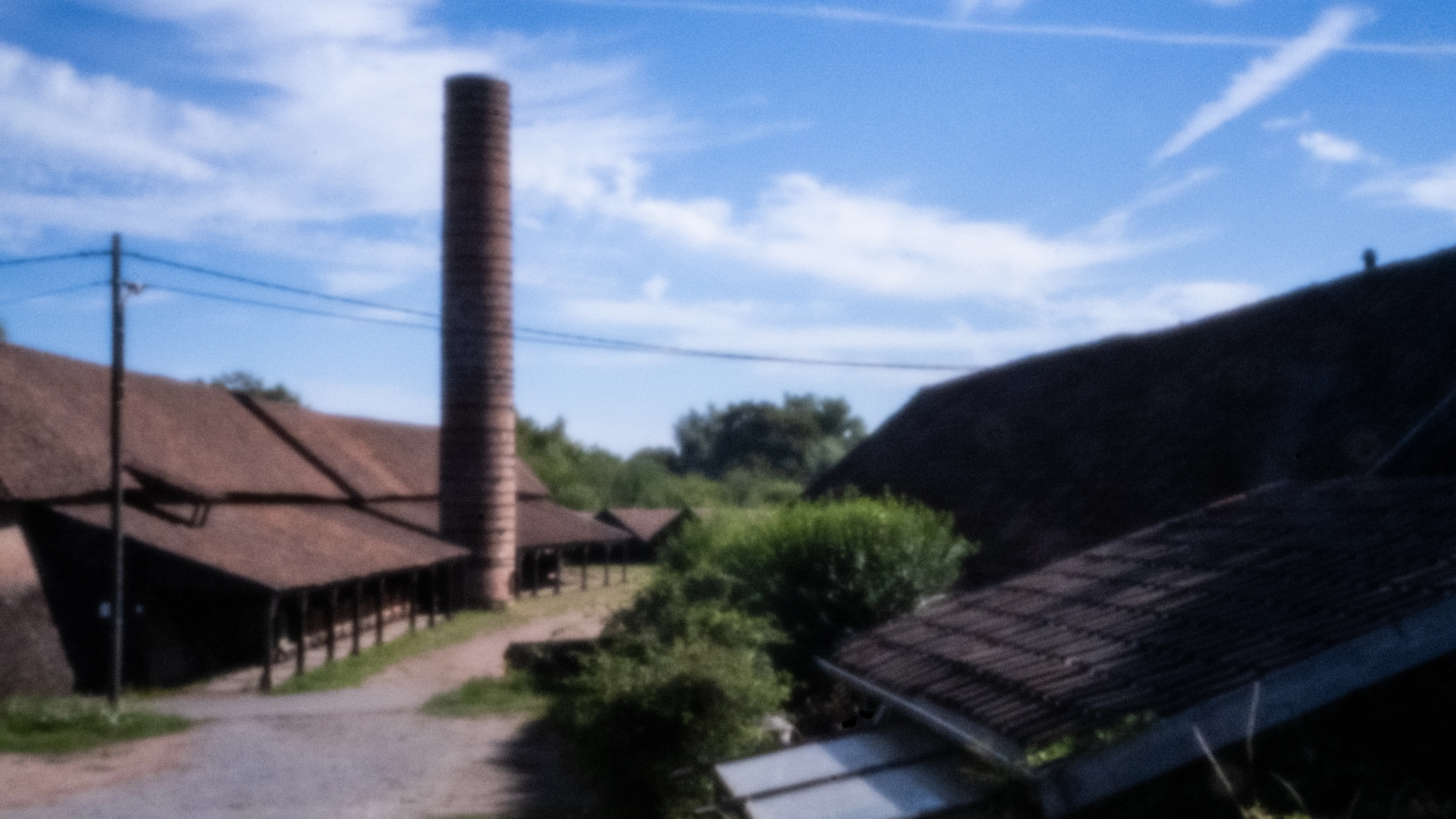 Factory chimney and roofs of the old brickworks at Noeveren