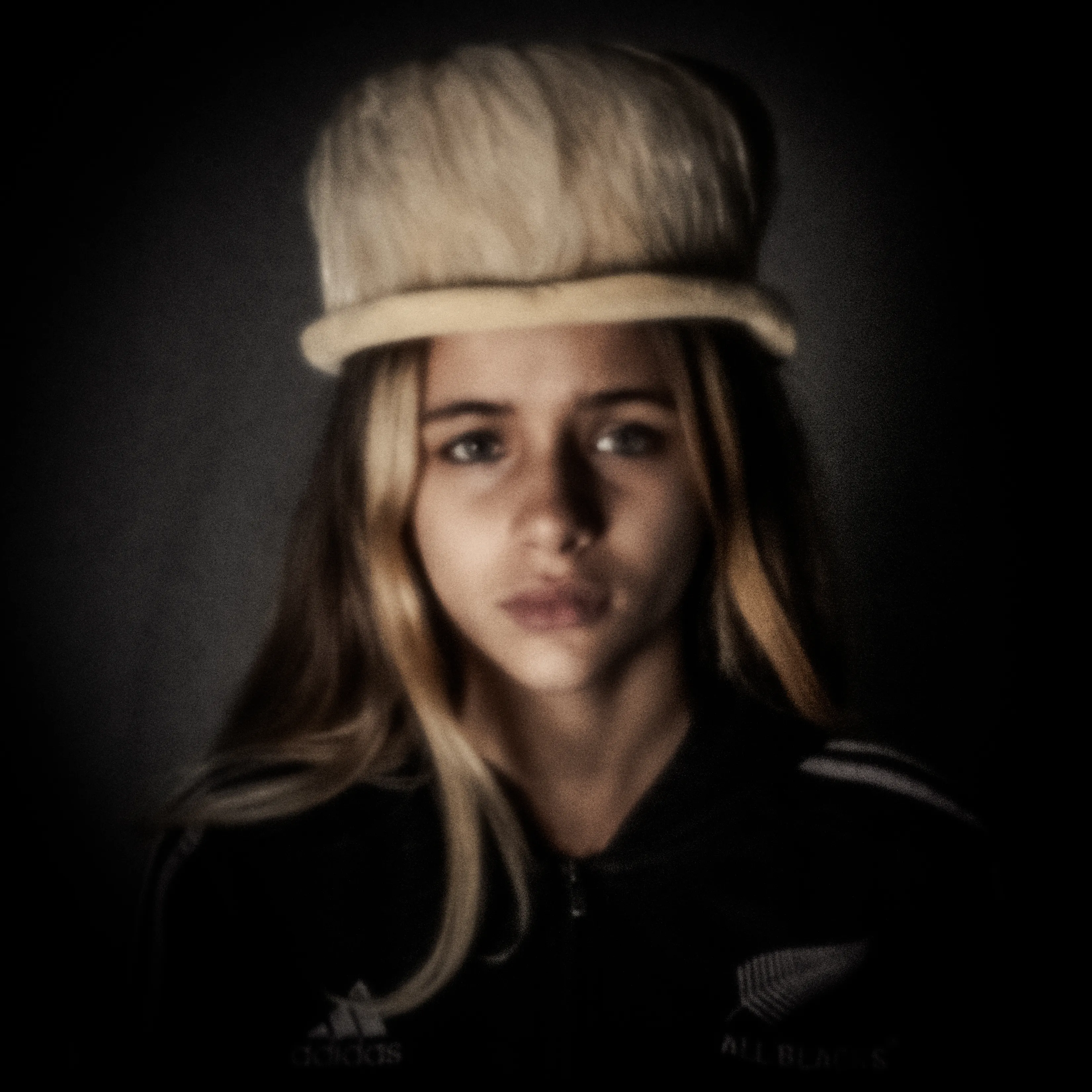 Dreamlike pinhole portrait of a girl in a large pale hat, in sepia
