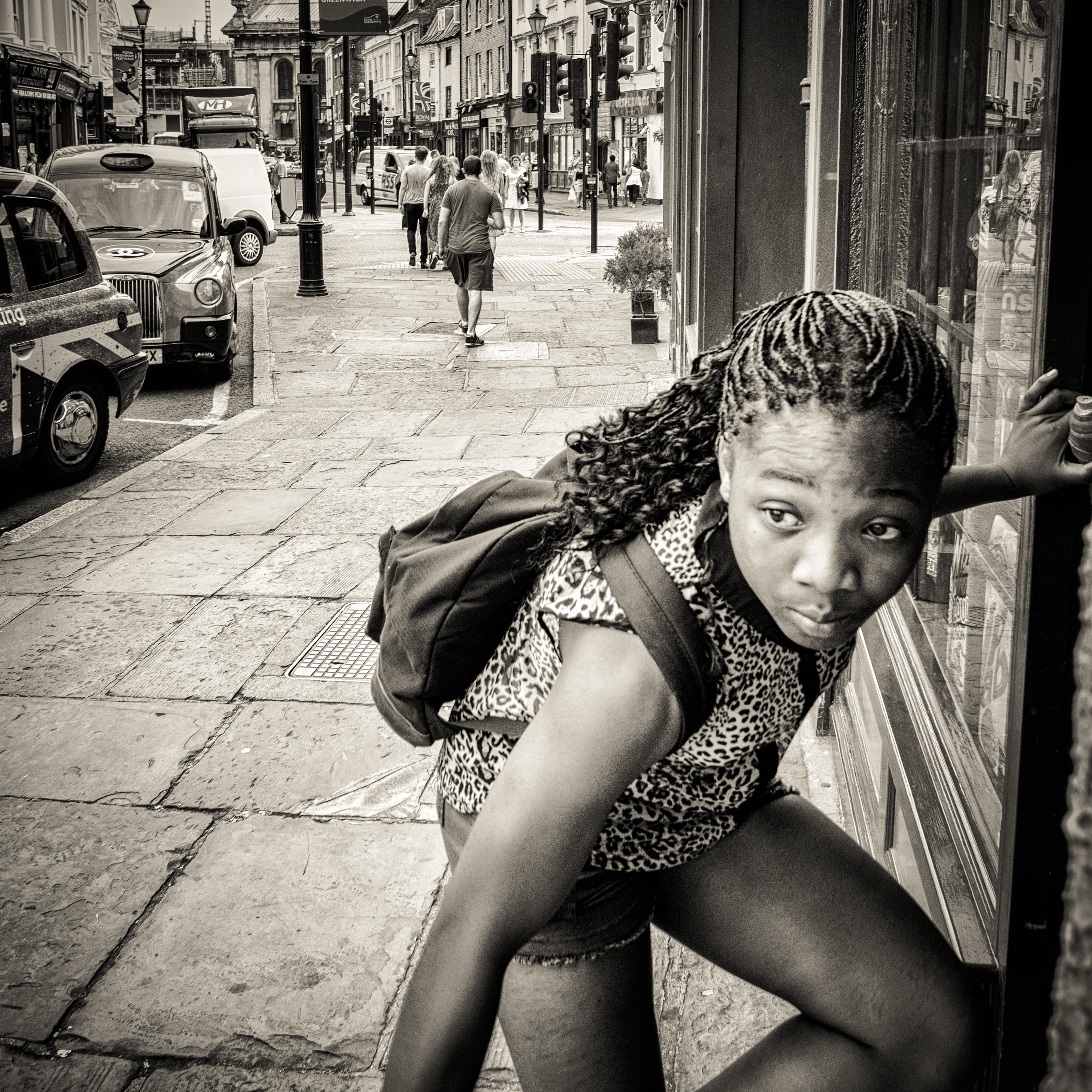 Girl glancing back over her shoulder in a London shopping street